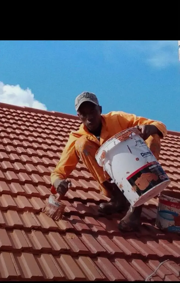 LTE team member applying a roof coating